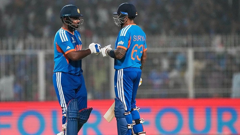 | Photo: AP/ Bikas Das : India's captain Suryakumar Yadav, right, and batting partner Sanju Samson touch gloves during the T20 World Cup cricket match between India and West Indies in Kolkata.