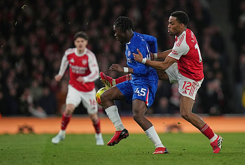Chelsea's Romeo Lavia, left, and Arsenal's Jurrien Timber fight for the ball during the Premier League soccer match between Chelsea Arsenal in London.