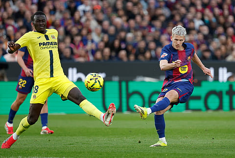 Barcelona's Dani Olmo, right, attempts a shot on goal as Villarreal's Pape Gueye defenses during the Spanish La Liga soccer match between Barcelona and Villareal in Barcelona, Spain.