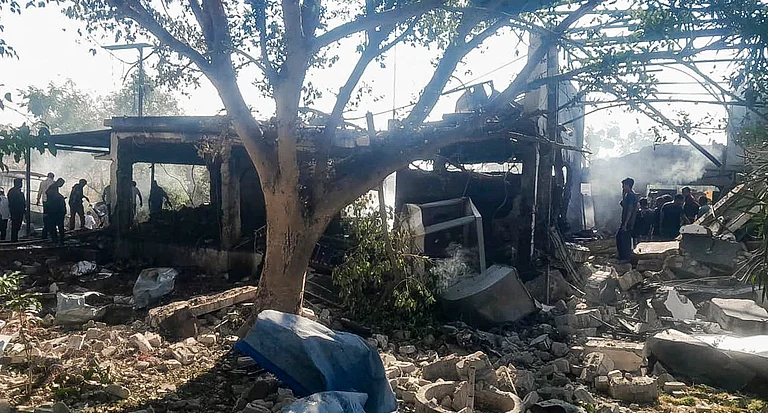 Security personnel and locals inspect the damaged premises after a blast at an explosives manufacturing factory, in Nagpur district, Sunday, Mar. 1, 2026. At least 15 persons were killed in the explosion at the SBL Energy Limited facility, according to police. - PTI