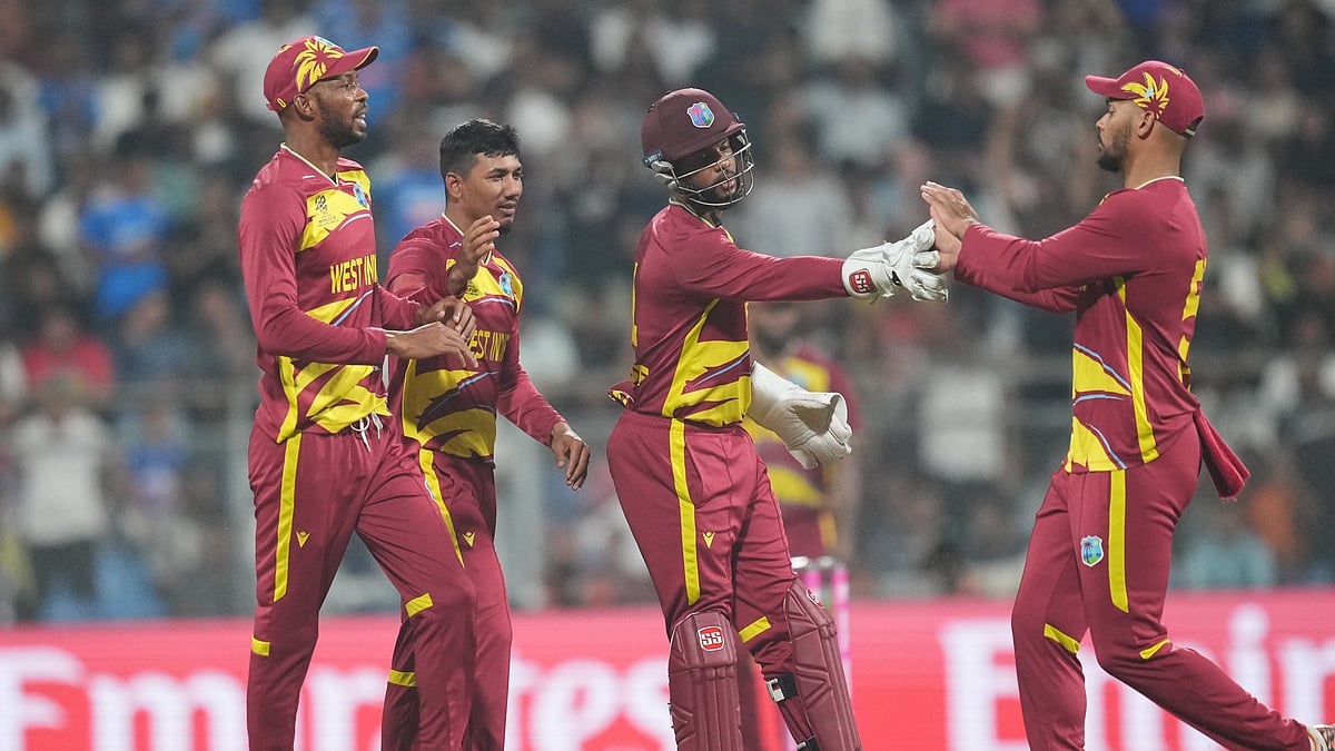 | Photo: AP/Rafiq Maqbool : West Indies' Gudakesh Motie, second from left, celebrates with teammates the wicket of England's Jacob Bethell during the T20 World Cup cricket match between England and West Indies in Mumbai, India, Wednesday, Feb. 11, 2026. 