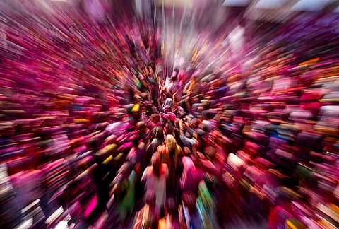 People daubed in vibrant colours during celebrations for the ‘Holi’ festival, at Shri Durgiana Temple in Amritsar.