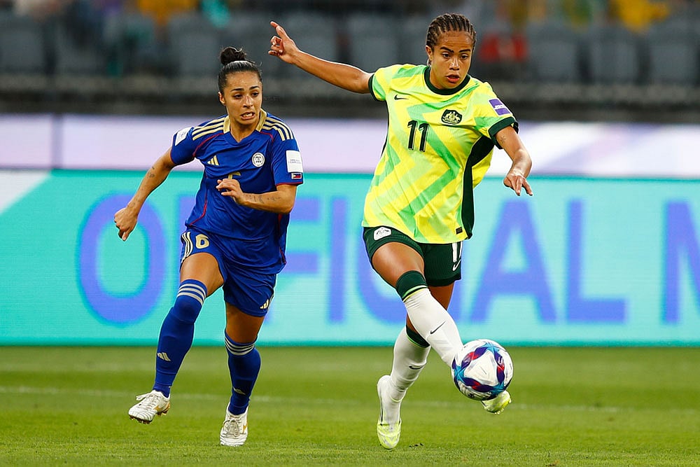 | Photo: AP/Gary Day : Australia's Mary Fowler kicks the ball clear of Philippines' Jaclyn Sawicki, left, during the Women's Asia Cup soccer match between Australia and the Philippines in Perth, Australia.
