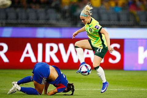 Australia's Ellie Carpenter and Philippines' Jaclyn Sawicki compete for the ball during the Women's Asia Cup soccer match between Australia and the Philippines in Perth, Australia.