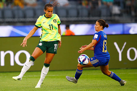 Australia's Mary Fowler and Philippines' Angela Bear, right, battle for the ball during the Women's Asia Cup soccer match between Australia and the Philippines in Perth, Australia.