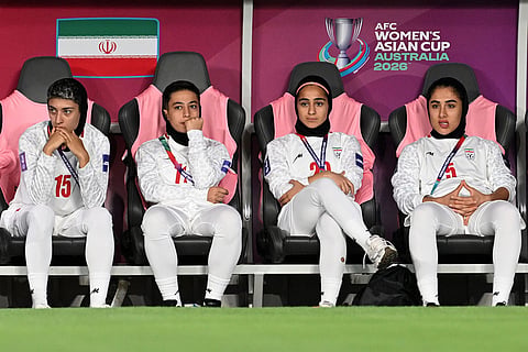 Iranian players watch from the bench during the Women's Asia Cup soccer match between Iran and South Korea on the Gold Coast, Australia.