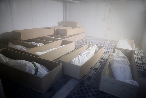 Coffins holding the bodies of mostly children sit in a room as they are prepared for the funeral of those killed in what Iranian officials said was an Israeli-U.S. strike Feb. 28 at a girls' elementary school in Minab, Iran.