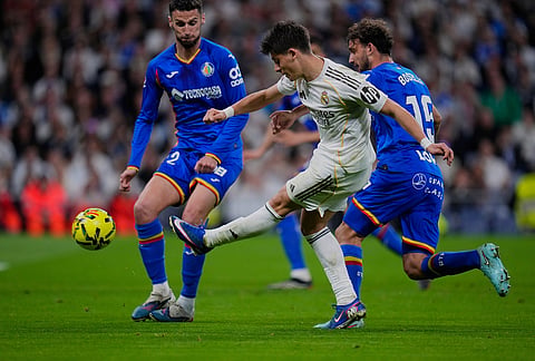 Real Madrid's Arda Guler kicks the ball during a Spanish La Liga soccer match between Real Madrid and Getafe in Madrid, Spain.
