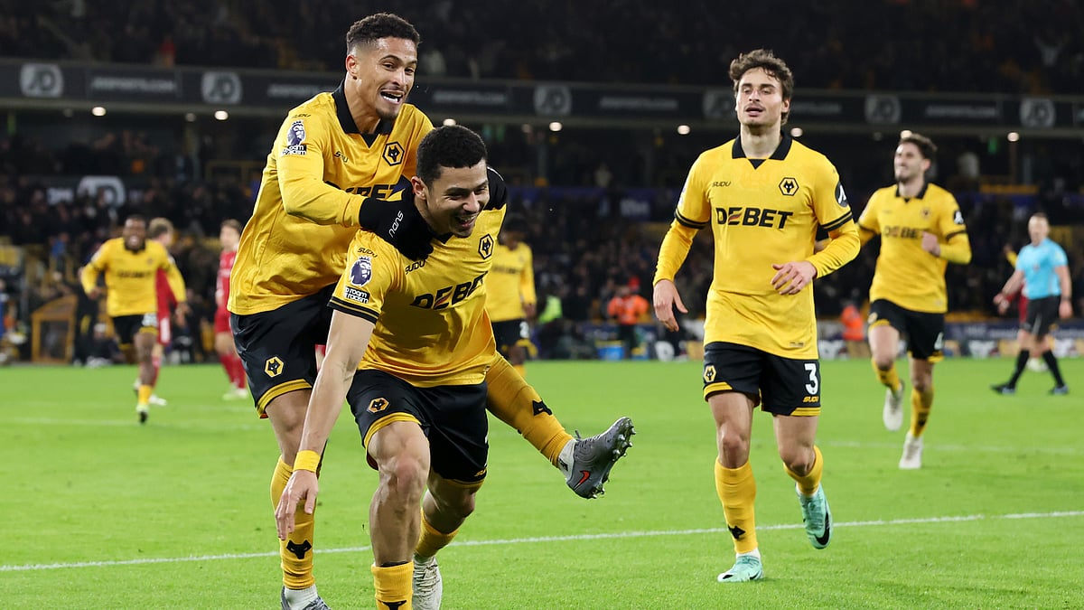 Andre is mobbed by his team-mates after scoring against Liverpool