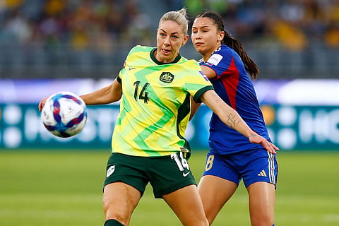 Australia's Alanna Kennedy, left, and Philippines' Sara Eggesvik compete for the ball during the Women's Asia Cup soccer match between Australia and the Philippines in Perth, Australia.