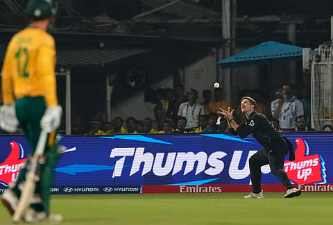 New Zealand's Lockie Ferguson takes the catch of South Africa's Quinton de Kock, left, during the first T20 World Cup cricket semifinal match between New Zealand and South Africa in Kolkata.