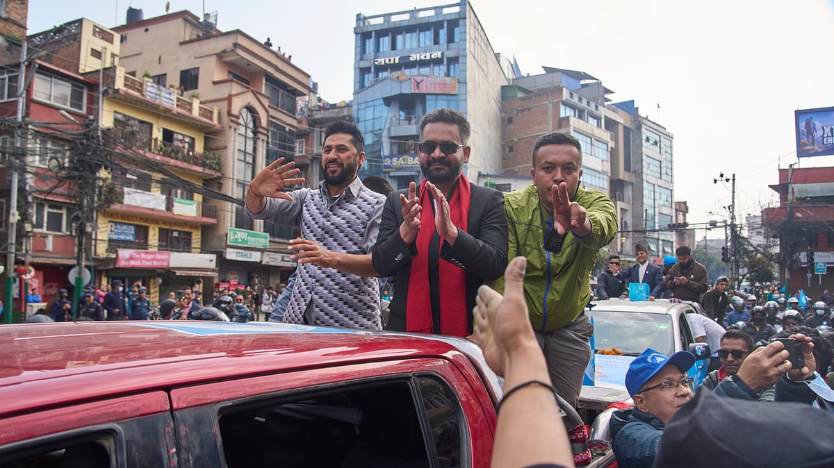 Photo: AP : Balendra Shah, center, former mayor of Kathmandu Metropolitan City and prime ministerial candidate of the Rastriya Swatantra Party, joins Rabi Lamichhane, left, the party's president, during an election campaign rally in Lalitpur, Nepal, Saturday, Feb. 28, 2026.