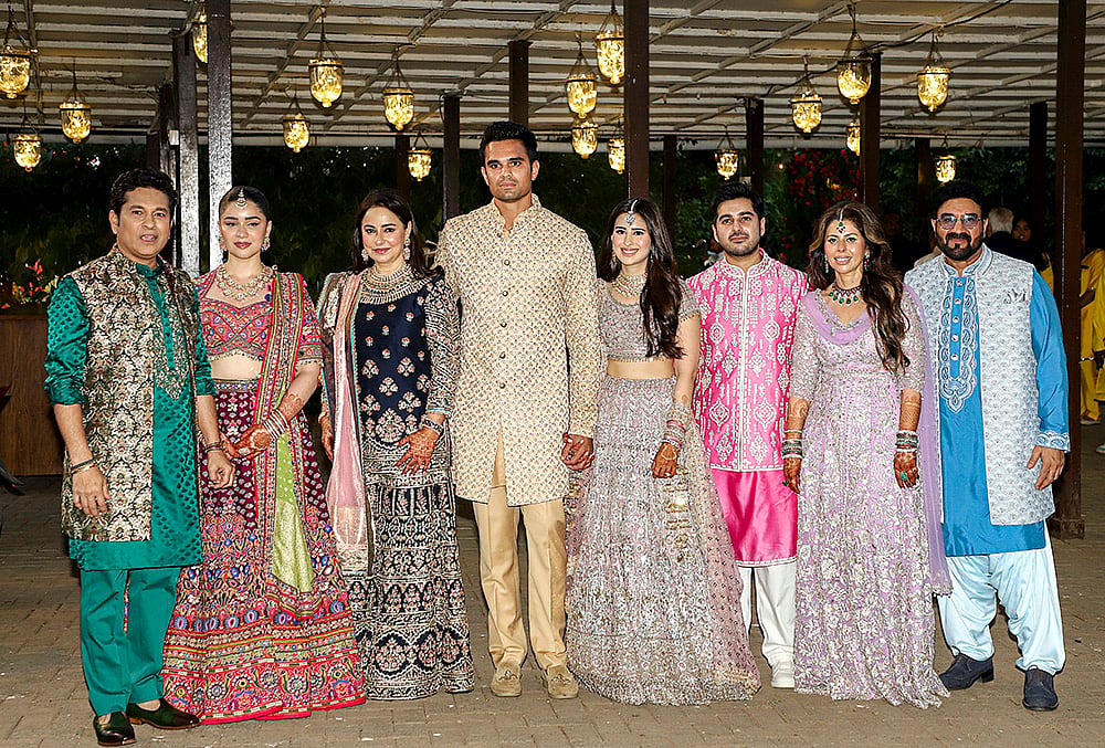 | Photo: PTI : Cricketer Arjun Tendulkar and Saaniya Chandhok, center, during their mehendi and sangeet ceremony, in Mumbai. Cricketer Sachin Tendulkar, left, his wife Anjali Tendulkar, third left, daughter Sara Tendulkar, second left, and others are also seen. 