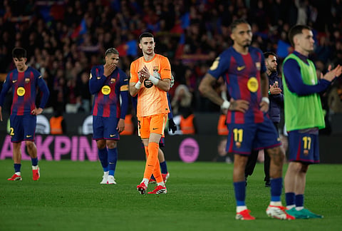 Barcelona's goalkeeper Joan Garcia applauds after the Copa del Rey semifinal second leg soccer match between Barcelona and Atletico Madrid in Barcelona, Spain.