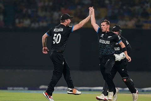 New Zealand's Cole McConchie, center, celebrates the wicket of South Africa's Ryan Rickelton during the first T20 World Cup cricket semifinal match between New Zealand and South Africa in Kolkata.