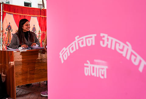 A polling official makes final arrangements at a polling station ahead of Nepal’s parliamentary elections, at Durbar Square, in Kathmandu. Nepal is holding the elections on Thursday, a year after a youth-led uprising forced out the government chosen in the last elections. 