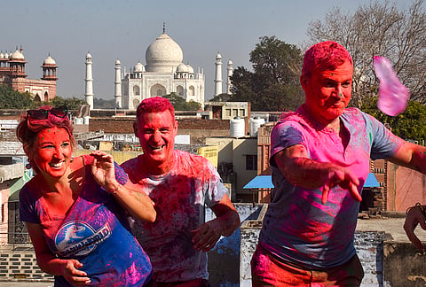 Foreign tourists celebrate the Holi festival near the Taj Mahal, in Agra, Uttar Pradesh.