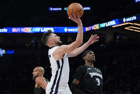 Memphis Grizzlies guard Ty Jerome shoots during the second half of an NBA basketball game against the Minnesota Timberwolves in Minneapolis.