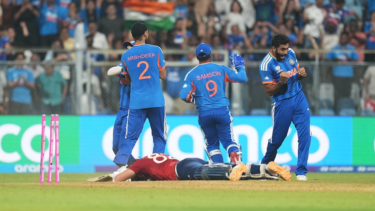 (AP Photo/Rafiq Maqbool) : England's Jacob Bethell lies on the ground as Indian players celebrate his run out during the T20 World Cup cricket semi-final match between India and England in Mumbai, India, Thursday, March 5, 2026