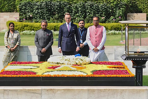 In this image posted on March 5, 2026, Finland President Alexander Stubb paid floral tributes to Mahatma Gandhi at Rajghat, New Delhi.