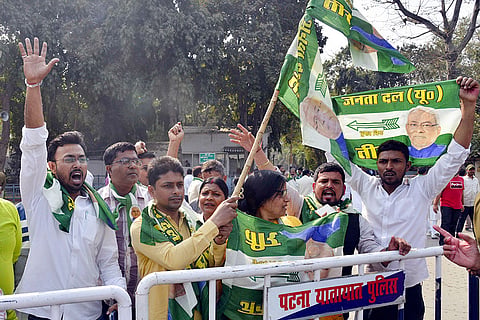 JD(U) supporters raise slogans outside the residence of Bihar CM Nitish Kumar as he is likely to file nomination papers for the Rajya Sabha polls, according to party leaders, in Patna.