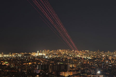 Tracer rounds light the sky as people fire live rounds into the air during a televised speech by Hezbollah leader Naim Kassem in Dahiyeh, Beirut's southern suburbs, Lebanon.