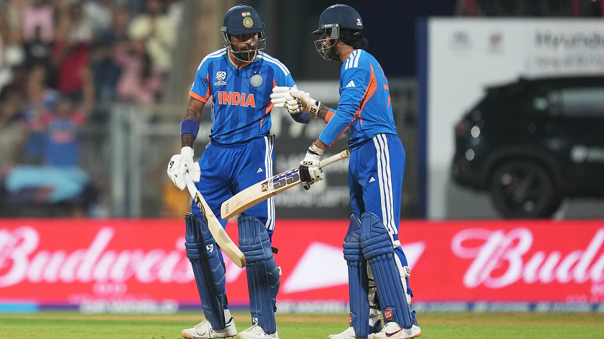 (AP Photo/Rafiq Maqbool) : India's Hardik Pandya, left, and batting partner Tilak Varma celebrate scoring runs during the T20 World Cup cricket semi-final match between India and England in Mumbai, India, Thursday, March 5, 2026