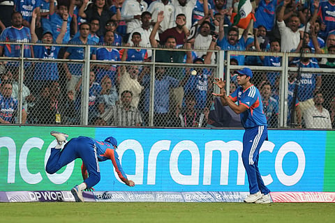 India's Axar Patel, left, passes the ball to teammate Shivam Dube to dismiss England's Will Jacks during the T20 World Cup cricket semi-final match between India and England in Mumbai, India.