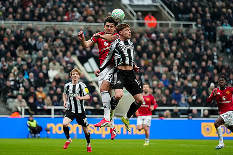Manchester United's Harry Maguire, left, and Newcastle United's Harvey Barnes in action during their English Premier League soccer match in Newcastle, England.