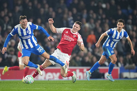 Brighton's Pascal Gross, left, and Arsenal's Viktor Gyoekeres during the Premier League soccer match between Brighton and Arsenal in Brighton, England.
