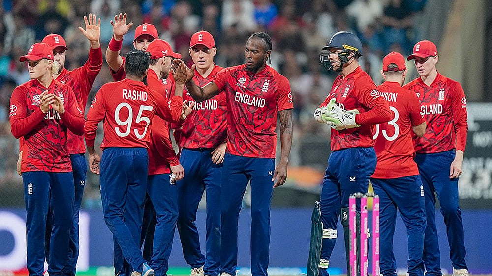 | Photo: PTI/Kunal Patil : England's Adil Rashid celebrates with teammates after a DRS review for the wicket of West Indies' Roston Chase during an ICC Men's T20 World Cup 2026 cricket match between England and West Indies, at the Wankhede Stadium, in Mumbai, Maharashtra.
