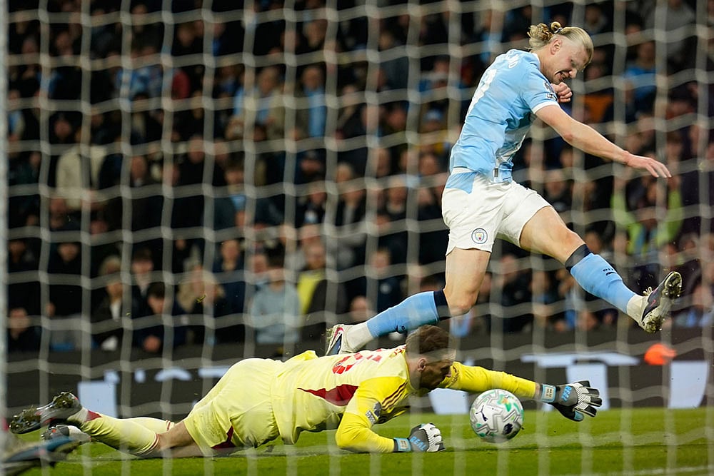 | Photo: AP/Dave Thompson : Nottingham Forest's goalkeeper Matz Sels saves at the feet of Manchester City's Erling Haaland during the English Premier League soccer match between Manchester City and Nottingham Forest in Manchester, England.
