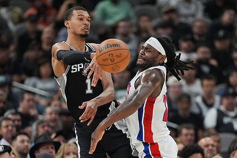 San Antonio Spurs forward Victor Wembanyama (1) passes the ball past Detroit Pistons forward Isaiah Stewart (28) during the first half of an NBA basketball game in San Antonio.
