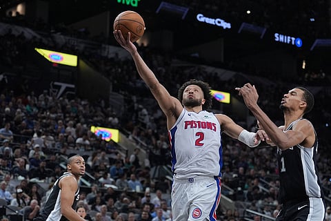 Detroit Pistons guard Cade Cunningham (2) drives to the basket past San Antonio Spurs forward Victor Wembanyama (1) during the first half of an NBA basketball game in San Antonio.