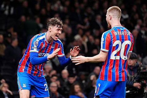 Crystal Palace's Jorgen Strand Larsen, left, celebrates with Adam Wharton after scoring their second goal of the game during the English Premier League soccer match between Tottenham Hotspur and Crystal Palace in London.