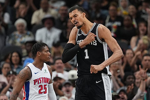 San Antonio Spurs forward Victor Wembanyama (1) reacts to a play against the Detroit Pistons during the first half of an NBA basketball game in San Antonio.