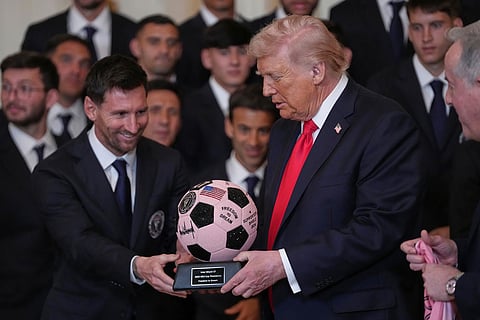 President Donald Trump receives a soccer ball trophy from Lionel Messi during an event to honor the 2025 Major League Soccer champions Inter Miami in the East Room of the White House in Washington.