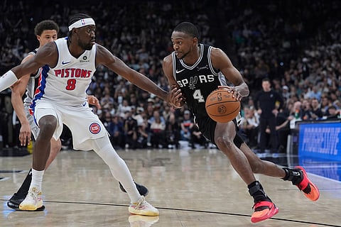 San Antonio Spurs guard De'aaron Fox (4) drives against Detroit Pistons guard Caris LeVert (8) during the second half of an NBA basketball game in San Antonio.