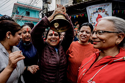 Supporters of the Rastriya Swatantra Party (RSP) ring a bell, the party’s election symbol, outside the Election Commission ahead of the announcement of results in the Nepal general elections, in Kathmandu, Nepal.