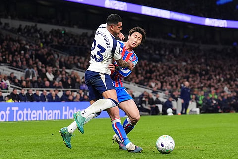 Tottenham Hotspur's Pedro Porro, left, and Crystal Palace's Daichi Kamada in action during the English Premier League soccer match between Tottenham Hotspur and Crystal Palace in London.