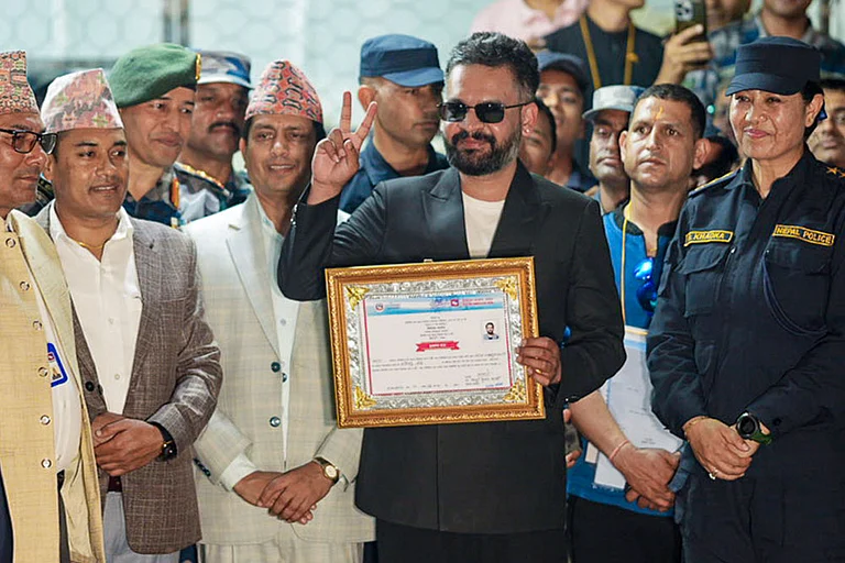 Balendra Shah, a candidate of the Rastriya Swatantra Party (RSP) from Jhapa Constituency-5, shows a certificate at the Election Commission premises after winning the constituency in the Nepal general elections, in Jhapa, Nepal. Balendra Shah 'Balen' defeated four-time prime minister K P Sharma Oli by a huge margin of about 50,000 votes. - Photo: PTI