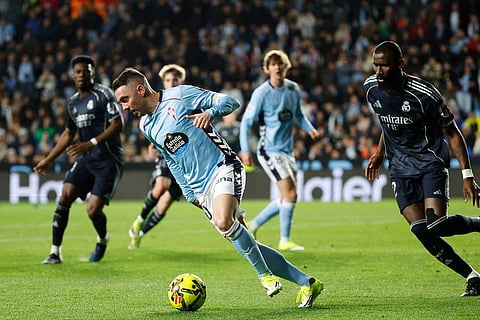 Celta's Iago Aspas, left, vies for the ball with Real Madrid's Antonio Rudiger during a Spanish La Liga soccer match between Celta Vigo and Real Madrid in Vigo, Spain.