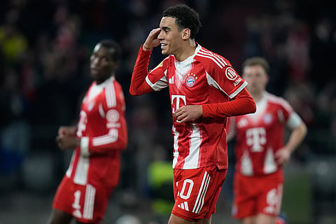 Bayern's Jamal Musiala celebrates after scoring from the penalty spot his side's third goal during the Bundesliga soccer match between FC Bayern Munich and Borussia Moenchengladbach in Munich, Germany.