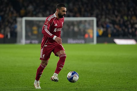 Liverpool's Mohamed Salah controls the ball during the English FA Cup soccer match between Wolves and Liverpool in Wolverhampton, England.