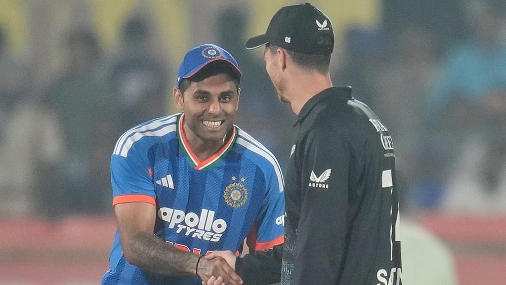 | Photo: AP/Aijaz Rahi : India's captain Suryakumar Yadav, left, shakes hand with New Zealand's captain Mitchel Santner after the toss at the start of the fourth T20 cricket match between India and New Zealand in Visakhapatnam.