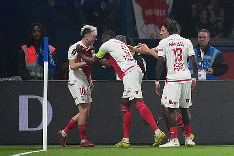 Monaco's Aleksandr Golovin (10) is congratulated after scoring his side's 2nd goal during the French League One soccer match between Paris Saint-Germain and Monaco in Paris.