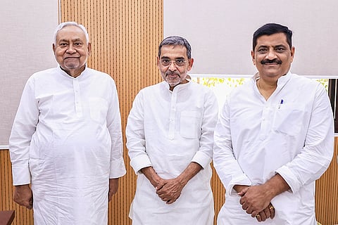 Bihar Chief Minister Nitish Kumar, left, with JD(U) National Working President Sanjay Jha, right, and Rashtriya Lok Morcha (RLM) chief Upendra Kushwaha during a meeting, in Patna.