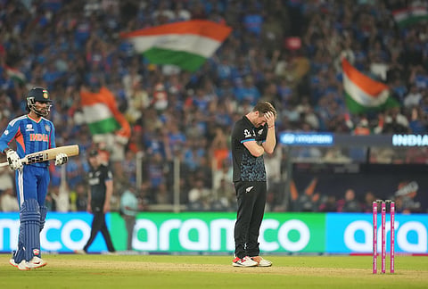 New Zealand's James Neesham reacts after New Zealand's captain Mitchel Santner drops a catch during the T20 World Cup cricket final match between India and New Zealand in Ahmedabad.