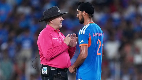 Umpire Richard Illingworth speaks with India's Arshdeep Singh after a misguided throw by the latter hit New Zealand's Daryl Mitchell's bat during the T20 World Cup cricket final match between India and New Zealand in Ahmedabad, India, Sunday, March 8, 2026.