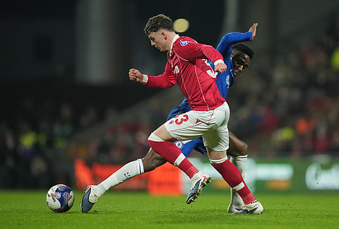Wrexham's Nathan Broadhead, front, and Chelsea's Dario Essugo fight for the ball during the fifth round FA Cup soccer match between Wrexham and Chelsea in Wrexham, Wales.